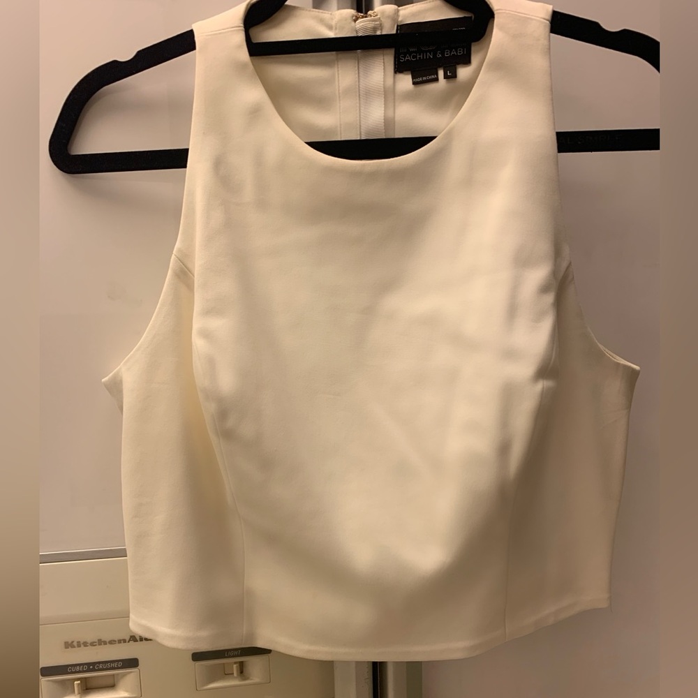 Very stylish off white cropped top with 4 cutouts in the back.